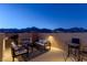 Atmospheric rooftop deck at dusk with a fireplace, seating area, and scenic mountain backdrop at 436 Trevinca St, Las Vegas, NV 89138