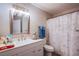 Bathroom featuring a vanity with a sink, toilet, and shower with a stylish marble curtain at 4555 E Sahara Ave # 132, Las Vegas, NV 89104