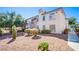 Exterior view of a two-story condo featuring a balcony, manicured bushes, and desert landscaping at 4555 E Sahara Ave # 132, Las Vegas, NV 89104