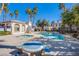 Community pool and spa area, with a picnic table, palm trees, and a secure gated fence at 4555 E Sahara Ave # 132, Las Vegas, NV 89104