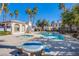 Community pool and hot tub area with lounge seating offers a relaxing oasis in a tropical setting with palm trees at 4555 E Sahara Ave # 132, Las Vegas, NV 89104