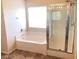 Bright bathroom features a tub and shower with glass doors at 4905 Morning Falls Ave, Las Vegas, NV 89131