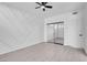 The empty bedroom features light gray floors, a ceiling fan, and a mirrored closet at 5155 W Tropicana Ave # 1052, Las Vegas, NV 89103