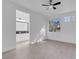 This bedroom features grey floors, a ceiling fan, and an entry to the bathroom at 5155 W Tropicana Ave # 1052, Las Vegas, NV 89103