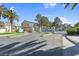 View of the property entrance gate and landscaping with palm trees at 5155 W Tropicana Ave # 1052, Las Vegas, NV 89103