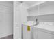 Functional laundry area with washer, dryer, and storage shelves at 5155 W Tropicana Ave # 1052, Las Vegas, NV 89103