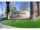 Property sign with fresh landscaping and surrounded by palm trees on a sunny day at 5155 W Tropicana Ave # 1052, Las Vegas, NV 89103