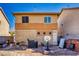 Backyard view featuring a barbecue grill, basketball hoop, and a two-story home with a brick wall at 5179 Floralita St, Las Vegas, NV 89122