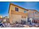 Backyard view featuring a barbecue grill, basketball hoop, and a two-story home at 5179 Floralita St, Las Vegas, NV 89122