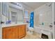 Clean bathroom featuring a single sink vanity and shower-tub with a bright blue shower curtain at 5179 Floralita St, Las Vegas, NV 89122