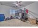 Bedroom with carpet flooring featuring a ceiling fan and a black bunk bed with lots of storage at 5179 Floralita St, Las Vegas, NV 89122