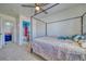 Bright bedroom featuring a ceiling fan, carpet flooring, and a four post bed frame at 5179 Floralita St, Las Vegas, NV 89122