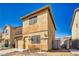 Cozy two-story home with tan stucco, attached garage, and low-maintenance yard at 5179 Floralita St, Las Vegas, NV 89122