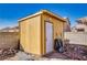 Outdoor shed featuring vertical siding, a secure door, and functional storage for yard tools at 5179 Floralita St, Las Vegas, NV 89122