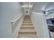 Carpeted staircase leading up to a hallway with a laundry area and a ceiling fan at 5179 Floralita St, Las Vegas, NV 89122