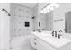 Bathroom showcasing tub with geometric-patterned tile and dual sinks at 5225 W Reno Ave # 105, Las Vegas, NV 89118