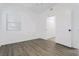 Bright bedroom featuring neutral walls, wood-look vinyl floors, and a sliding door closet at 5225 W Reno Ave # 105, Las Vegas, NV 89118