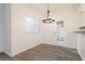 Dining area featuring wood floors, bright lighting, and a door with glass panels at 5225 W Reno Ave # 105, Las Vegas, NV 89118