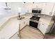 Modern kitchen with stainless steel appliances, white cabinetry, quartz countertops, and subway tile backsplash at 5225 W Reno Ave # 105, Las Vegas, NV 89118