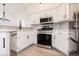 Bright kitchen features stainless steel appliances and white cabinets at 5225 W Reno Ave # 105, Las Vegas, NV 89118