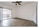 Living room with vinyl wood floors, large sliding glass door, and bright walls at 5225 W Reno Ave # 105, Las Vegas, NV 89118