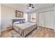 Cozy bedroom with a queen bed, ceiling fan, closet, and warm wood flooring at 536 Greenbriar Pl, Boulder City, NV 89005