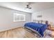 Bedroom with blue bedspread, ceiling fan and laminate floors at 536 Greenbriar Pl, Boulder City, NV 89005