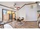 Dining area with wood-look floors, decorative ceiling fan and sliding doors to exterior courtyard at 536 Greenbriar Pl, Boulder City, NV 89005