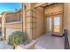 Inviting front entrance featuring glass paneled doors and a two-car garage with second story balcony at 536 Greenbriar Pl, Boulder City, NV 89005