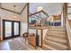 Grand foyer with wood-trimmed staircase and a stylish console table at 536 Greenbriar Pl, Boulder City, NV 89005