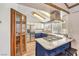 Kitchen with stainless appliances, modern vent hood and blue cabinets at 536 Greenbriar Pl, Boulder City, NV 89005