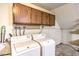 Functional laundry room featuring a washer, dryer, and overhead storage for convenience at 536 Greenbriar Pl, Boulder City, NV 89005