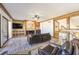 Bright living room featuring a fireplace, wet bar, and sliding glass doors to a balcony with scenic views at 536 Greenbriar Pl, Boulder City, NV 89005