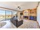 Bright living room with a cozy fireplace, wet bar and stunning views from the sliding glass doors to the balcony at 536 Greenbriar Pl, Boulder City, NV 89005