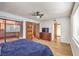 Spacious main bedroom with laminate floors, ceiling fan, and sliding door access to deck at 536 Greenbriar Pl, Boulder City, NV 89005