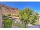 Community street view with desert landscaping and stunning mountain views at 536 Greenbriar Pl, Boulder City, NV 89005