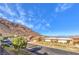 Charming street view showcases well-maintained homes with mature landscaping against a mountain backdrop at 536 Greenbriar Pl, Boulder City, NV 89005