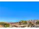 Scenic street view of well-kept homes with mature trees against a mountainous landscape at 536 Greenbriar Pl, Boulder City, NV 89005