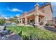 Beautiful backyard featuring a large in-ground pool, patio dining area and a well-manicured lawn at 5868 Revital Ct, Las Vegas, NV 89131