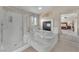 Bright bathroom featuring a jacuzzi tub with fireplace, and separate glass shower at 5868 Revital Ct, Las Vegas, NV 89131