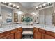 Luxurious bathroom featuring double sinks with wooden cabinetry and a vanity area with stylish decor at 5868 Revital Ct, Las Vegas, NV 89131