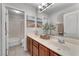 Bright bathroom featuring a double sink vanity, a large mirror, and a separate shower and tub at 5868 Revital Ct, Las Vegas, NV 89131