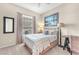 Cozy bedroom featuring a comfy bed with stylish linens and a window with natural light at 5868 Revital Ct, Las Vegas, NV 89131