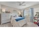 Cozy bedroom with a ceiling fan, dresser, and a cheerful decor at 5868 Revital Ct, Las Vegas, NV 89131