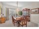 Classic dining room with a wooden table, chandelier, and hutch, perfect for Gathering gatherings at 5868 Revital Ct, Las Vegas, NV 89131