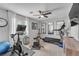 Home gym featuring a ceiling fan, mirrors, and a variety of exercise equipment at 5868 Revital Ct, Las Vegas, NV 89131