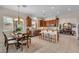 Bright kitchen with wood cabinets, granite counters, stainless steel appliances, and a dining area for casual meals at 5868 Revital Ct, Las Vegas, NV 89131