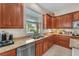 Kitchen with stainless steel appliances, granite counters, and a view of the backyard pool through a bright window at 5868 Revital Ct, Las Vegas, NV 89131