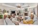 Bright and airy living room features a fireplace, cozy seating, and plenty of natural light from large windows at 5868 Revital Ct, Las Vegas, NV 89131