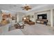 Spacious living room featuring a ceiling fan, comfortable seating, and seamless access to the kitchen area at 5868 Revital Ct, Las Vegas, NV 89131